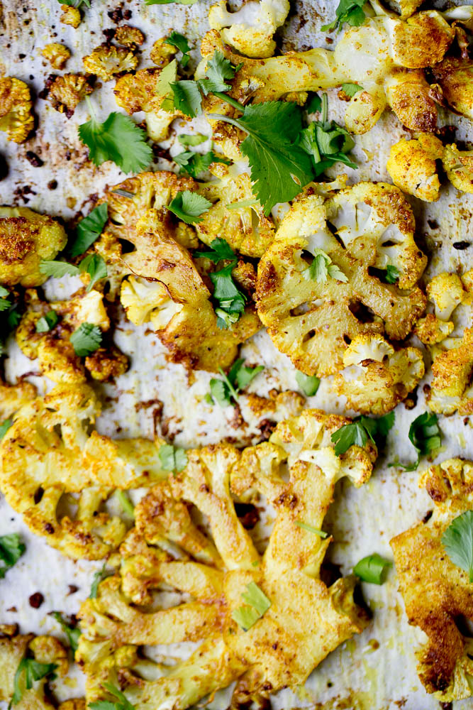 All you need is a head of cauliflower and some curry powder for a quick and easy side dish to serve alongside curry or anything off of the grill! | perrysplate.com #cauliflower #roastedvegetables