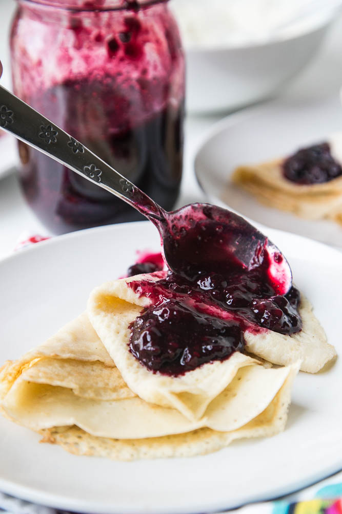 Keep a bag of frozen berries on hand to make this quick 3-ingredient sauce! Use it on crepes, waffles, pancakes, ice cream or over custard! | perrysplate.com #paleodessert #frozenberries #ketodessert