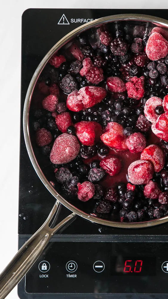 Keep a bag of frozen berries on hand to make this quick 3-ingredient sauce! Use it on crepes, waffles, pancakes, ice cream or over custard! | perrysplate.com #paleodessert #frozenberries #ketodessert