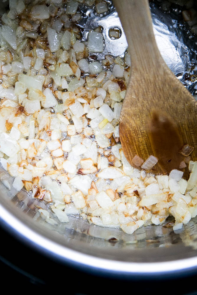 Sauteeing onions for my favorite classic Indian Curry and it's super easy to make in the Instant Pot. You can make it dairy free by using coconut milk, too! | perrysplate.com #instantpot #instantpotrecipes #indianfood