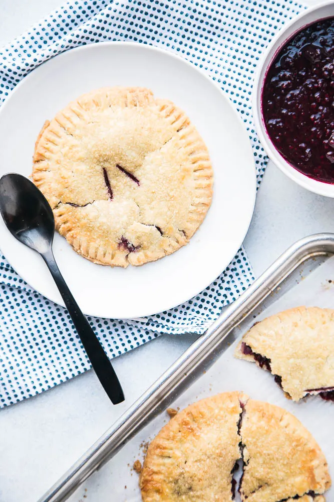 Gluten-Free Berry Hand Pies are made with the best gluten-free pie crust and easy filling! Top them with ice cream and extra berry sauce! | perrysplate.comGluten-Free Berry Hand Pies are made with the best gluten-free pie crust and easy filling! Top them with ice cream and extra berry sauce! | perrysplate.com