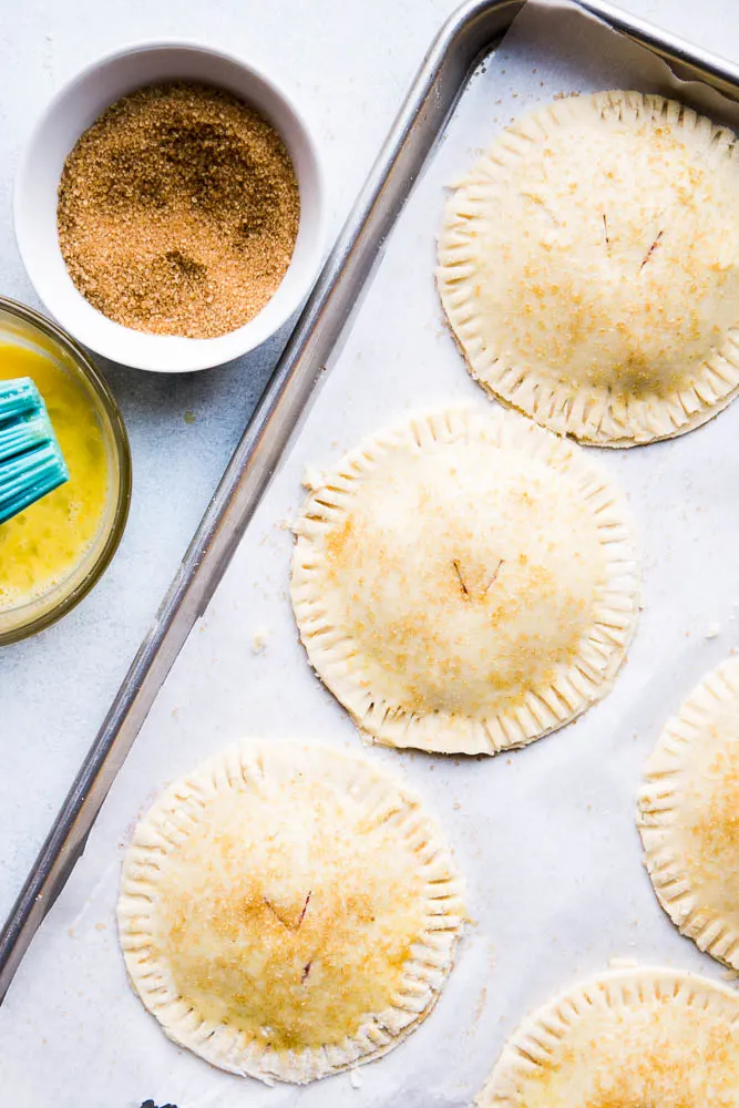 Brushing the gluten-free hand pies with an egg wash and sprinkling coarse sugar on them creates a beautiful golden, sparkly crust!