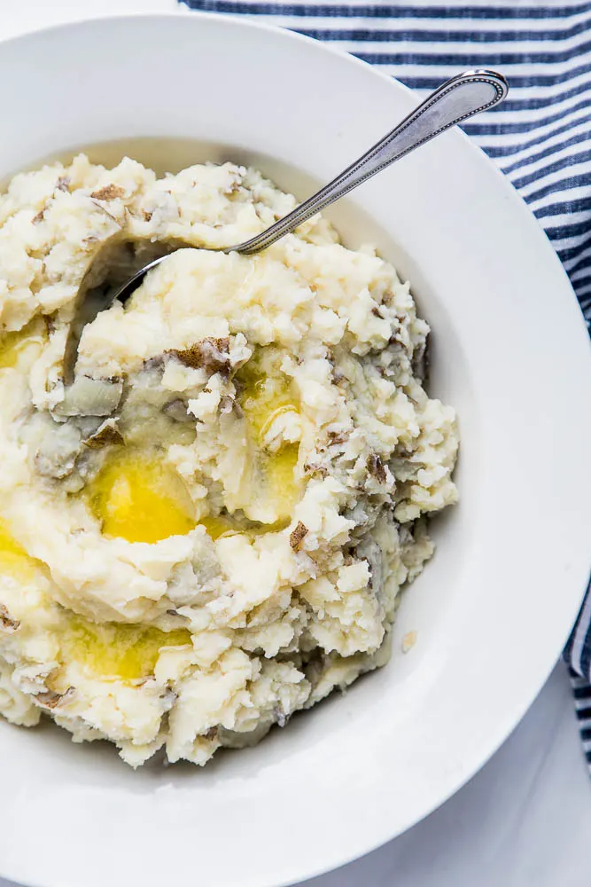 Another view of the serving bowl with the finished Instant Pot mashed potatoes.