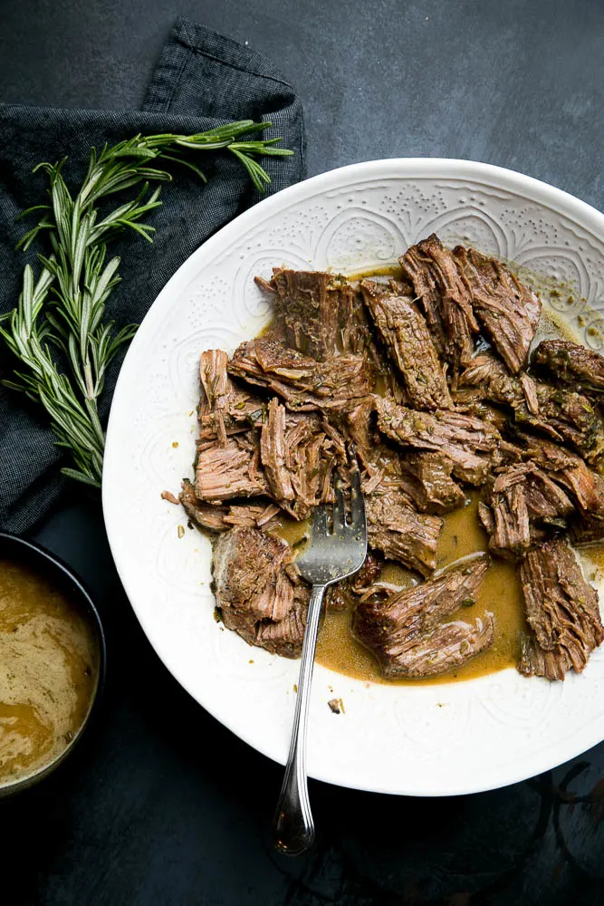 Instant Pot Pot Roast with Rosemary Gravy is an EASY weeknight meal, but special enough for company. Pair it with some mashed potatoes or roasted vegetables for a delicious meal.