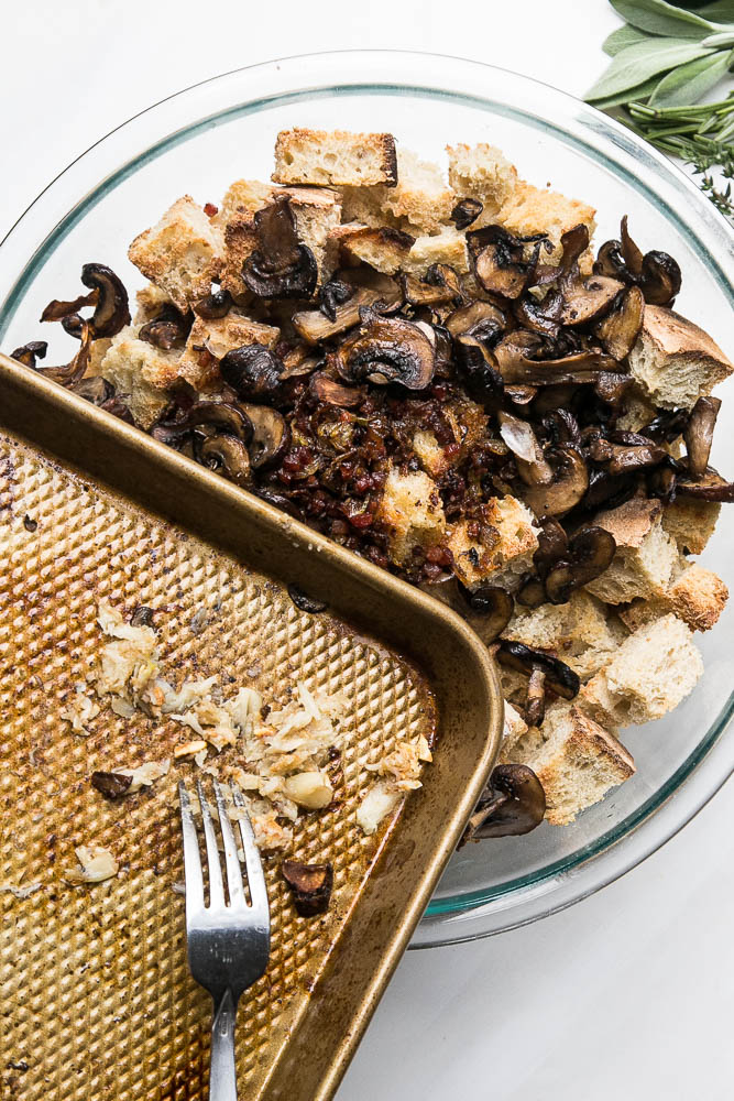Stuffing made with sourdough bread is the best! This version has roasted garlic, roasted mushrooms, and salty pancetta mixed in. Perfect for a classic Thanksgiving side. | perrysplate.com