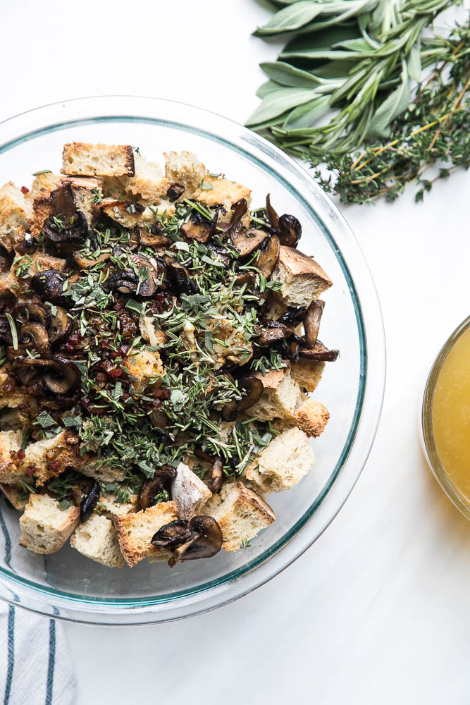 Stuffing made with sourdough bread is the best! This version has roasted garlic, roasted mushrooms, and salty pancetta mixed in. Perfect for a classic Thanksgiving side. | perrysplate.com