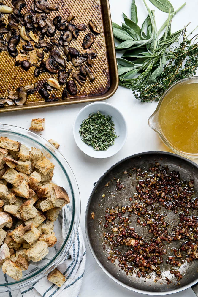 Stuffing made with sourdough bread is the best! This version has roasted garlic, roasted mushrooms, and salty pancetta mixed in. Perfect for a classic Thanksgiving side. | perrysplate.com