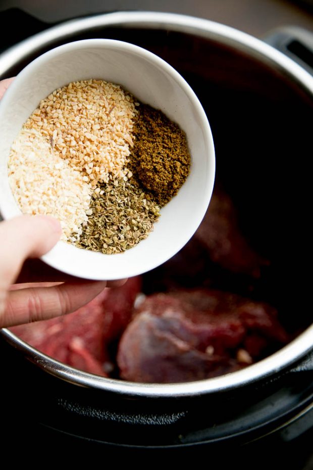 Just a few simple spices make the flavors in this shredded green chile beef POP Adding the spices to the Instant Pot for the shredded taco beef.