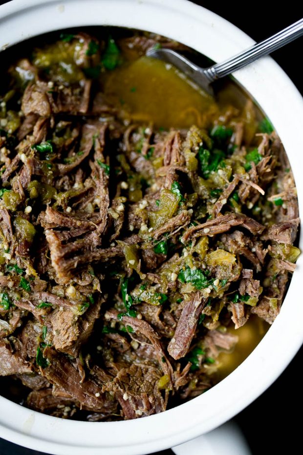 Serving dish full of shredded green chile beef ready to eat.