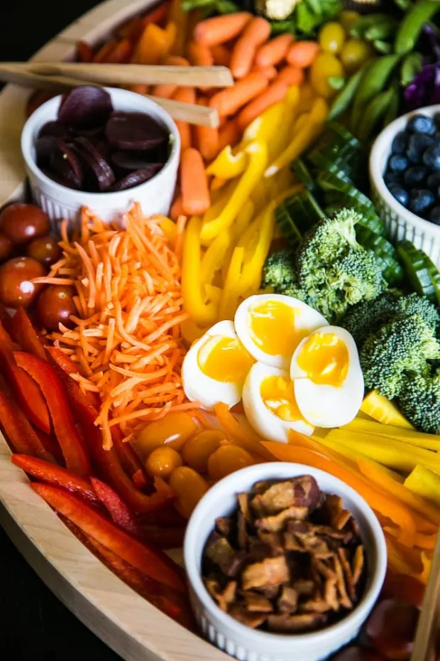 Charcuterie board filled with colorful vegetables and eggs perfect for spring or summer!