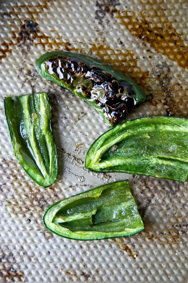 Roasting jalapenos is so easy! Just slice them in half, pull the seeds out, and roast them in a hot oven for 12 minutes. 