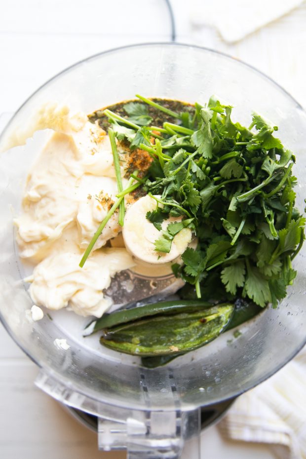 Ingredients for Roasted Jalapeno Paleo Ranch in the work bowl of a food processor. You can also use a blender. 