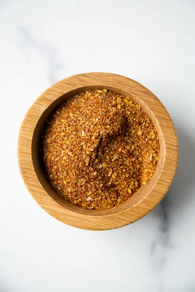 A small wooden bowl with Smoky Chipotle Taco Seasoning