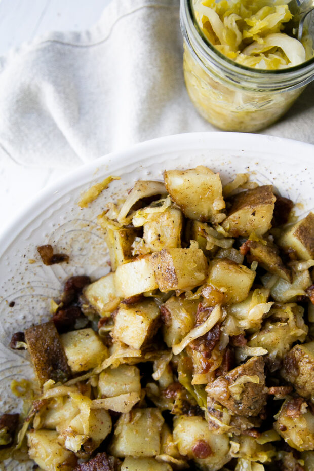 German Potato Salad with Bacon & Sauerkraut is a delicious (and sun-safe!) addition to a summer potluck!