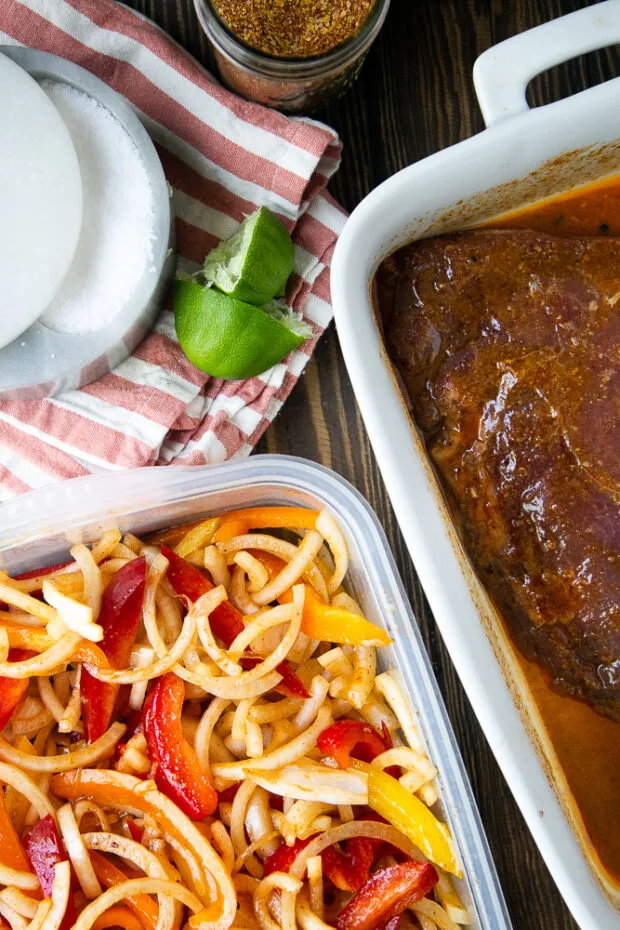 Marinated flank steak and peppers and onions, ready for grilling later.