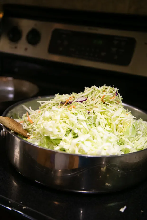 Making egg roll in a bowl using lots of shredded cabbage.