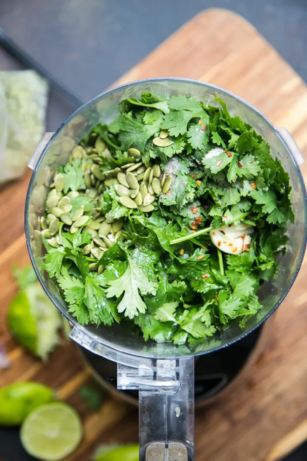 Put the cilantro in a food processor with some garlic, lime juice, and pepitas to make cilantro pesto.