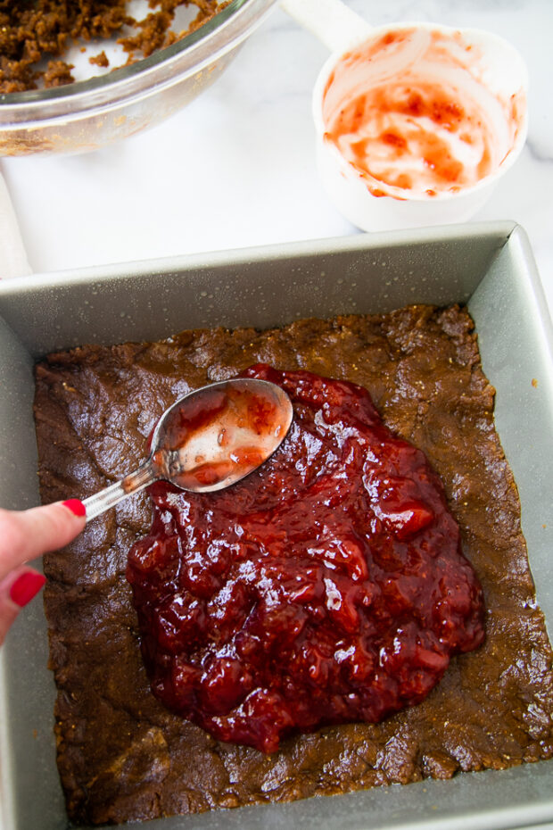 Strawberry jam is added to layers of peanut butter cookie crust!