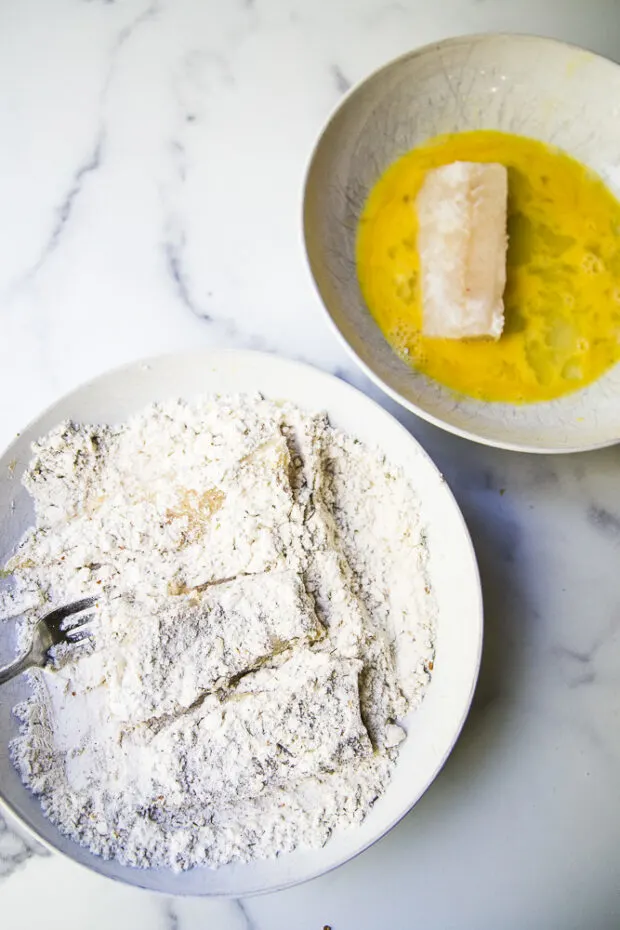 Lightly breaded cod fillets ready to fry for the fish fry.