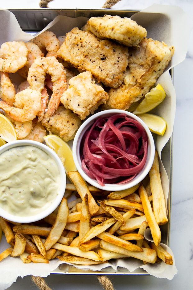 Fish Fry inspired by our trip to Aruba! Lightly breaded cod & shrimp served with garlic aioli and pickled red onions.