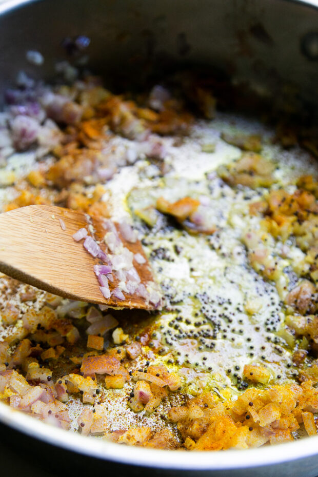 Onions, garlic, ginger, and spices sauteeing in a pan.