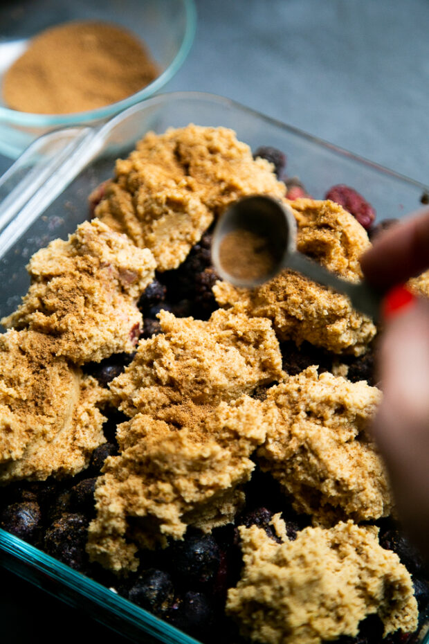 A sprinkle of cinnamon, coconut sugar, and cloves create a cracked snickerdoodle-like topping for the berry cobbler.