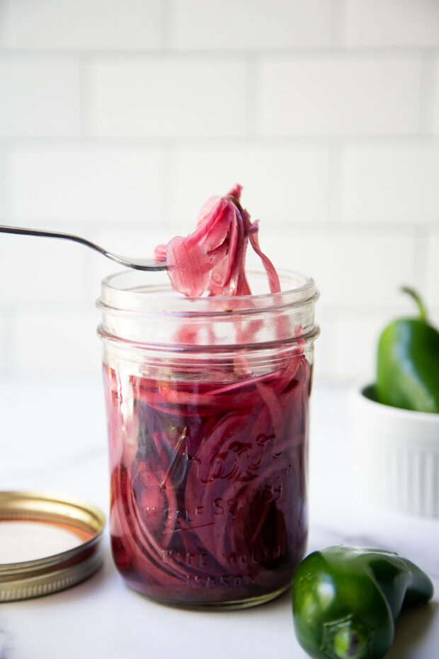 Pickled Red Onions with Garlic & Jalapeno in a mason jar ready to eat!