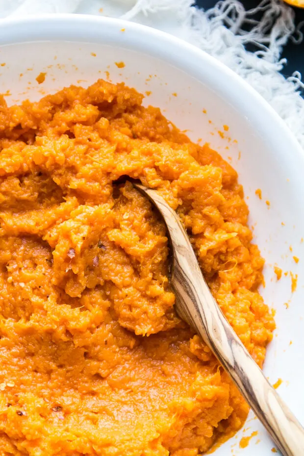 Another view of the large white serving bowl filled with Mashed Sweet Potatoes with Orange-Chili Butter.