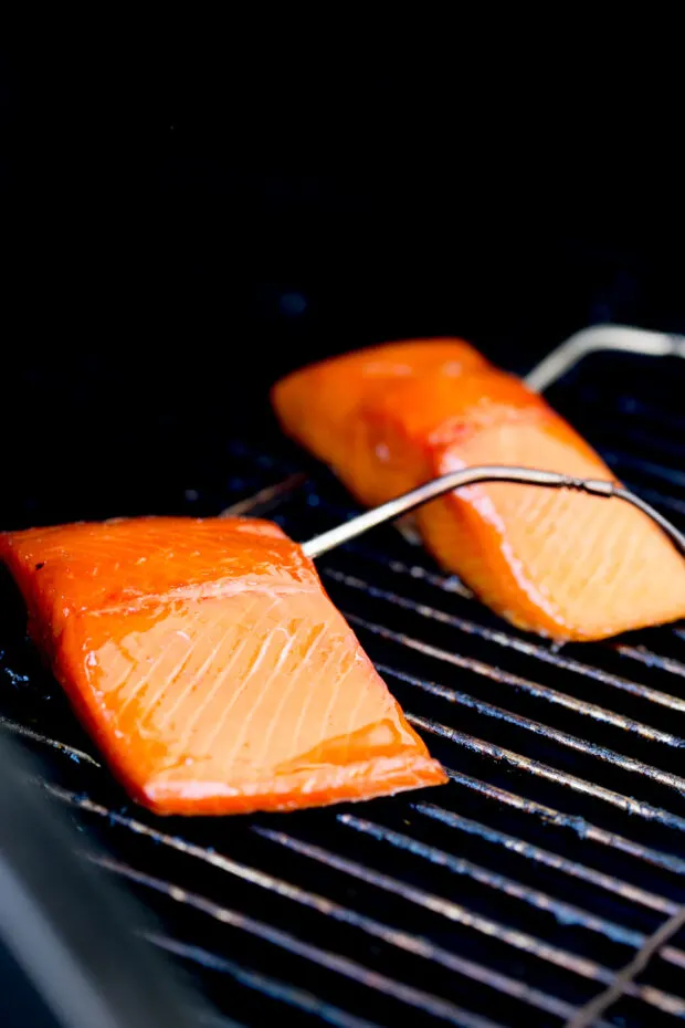 Finished smoked salmon on the grill with the temperature probes still inserted into the fish.