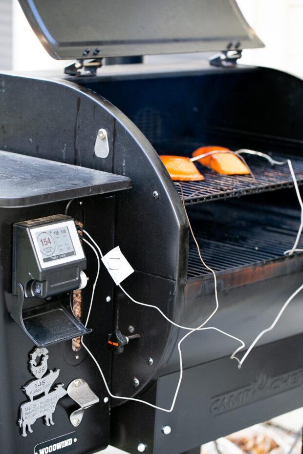 A wider view of the CampChef pellet grill showing the salmon fillets inside.
