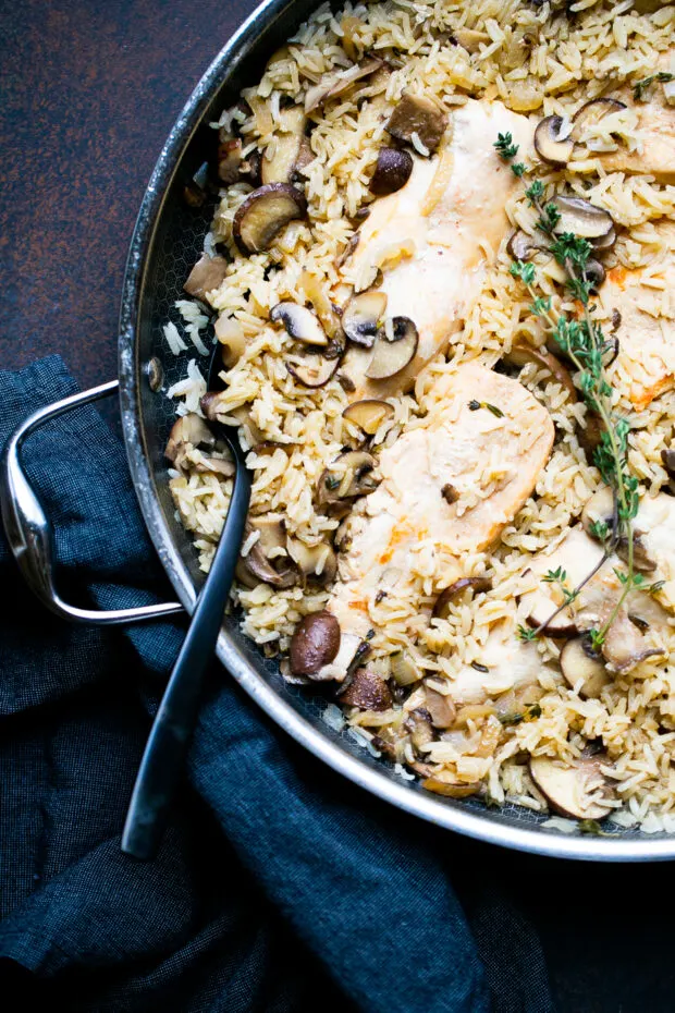 Finished Chicken Mushroom Rice Skillet with a black serving spoon.