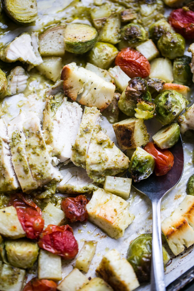 Baked Chicken Pesto with sliced chicken, roasted brussels, potatoes, cherry tomatoes and chunks of halloumi cheese.