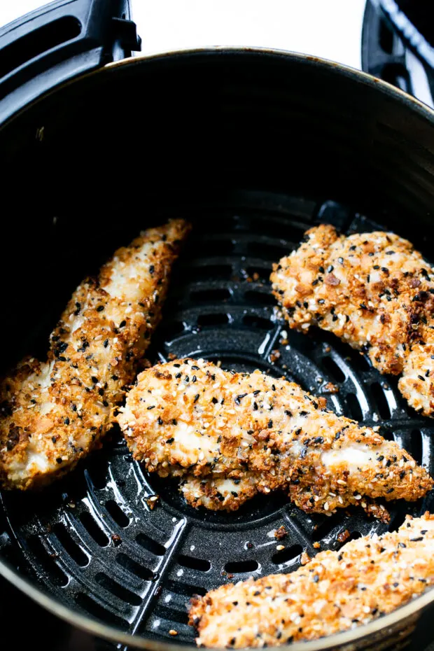 Chicken tenders fresh from the air fryer -- golden brown.