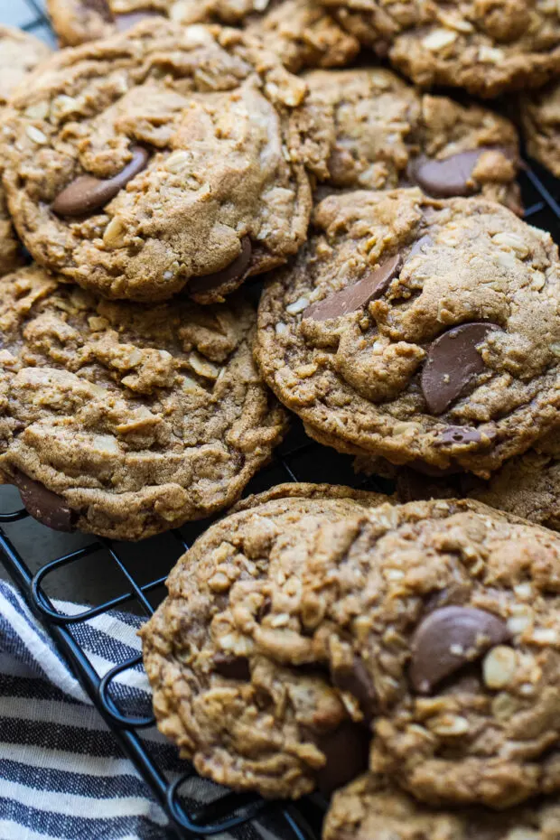 Gluten-Free Peanut Butter Oatmeal Chocolate Cookies stacked on a cooling rack.