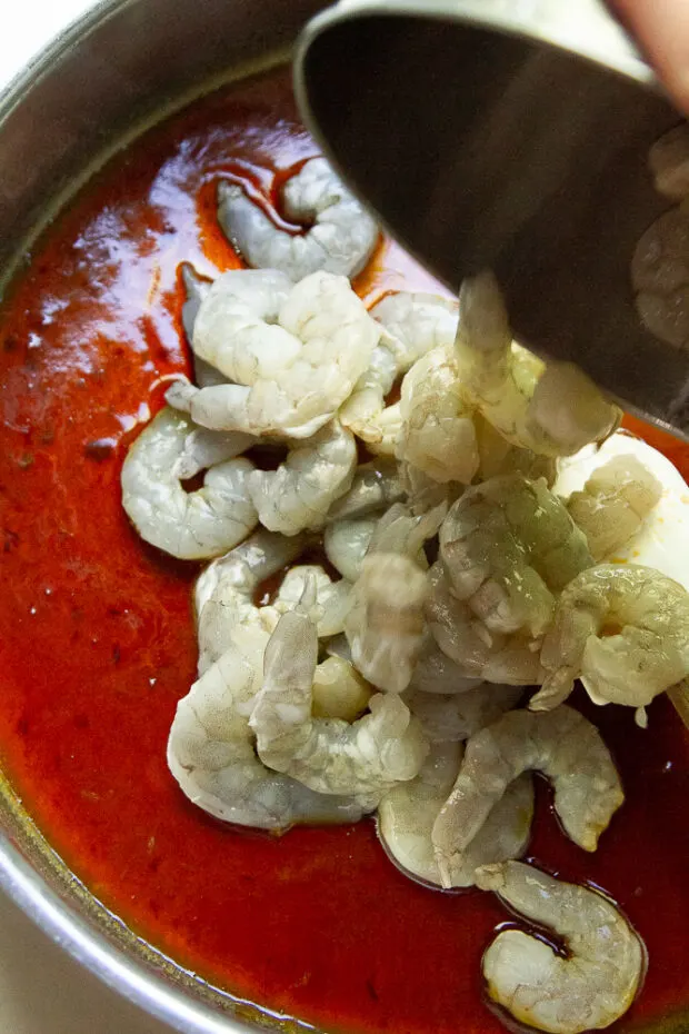 Raw shrimp added to the skillet with the finished sweet ginger-soy sauce.