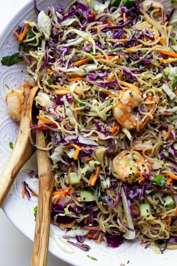 Shrimp & Ramen Noodle Bowl in a large serving bowl with wooden serving spoons.