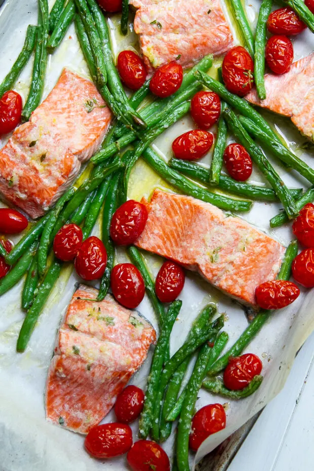 Finished Garlic Butter Sheet Pan Meal with green beans and grape tomatoes  fresh from the broiler.