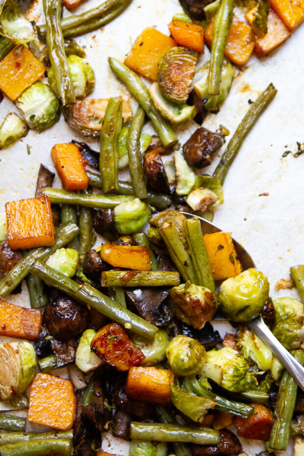 Freshly roasted balsamic vegetables on a sheet pan.