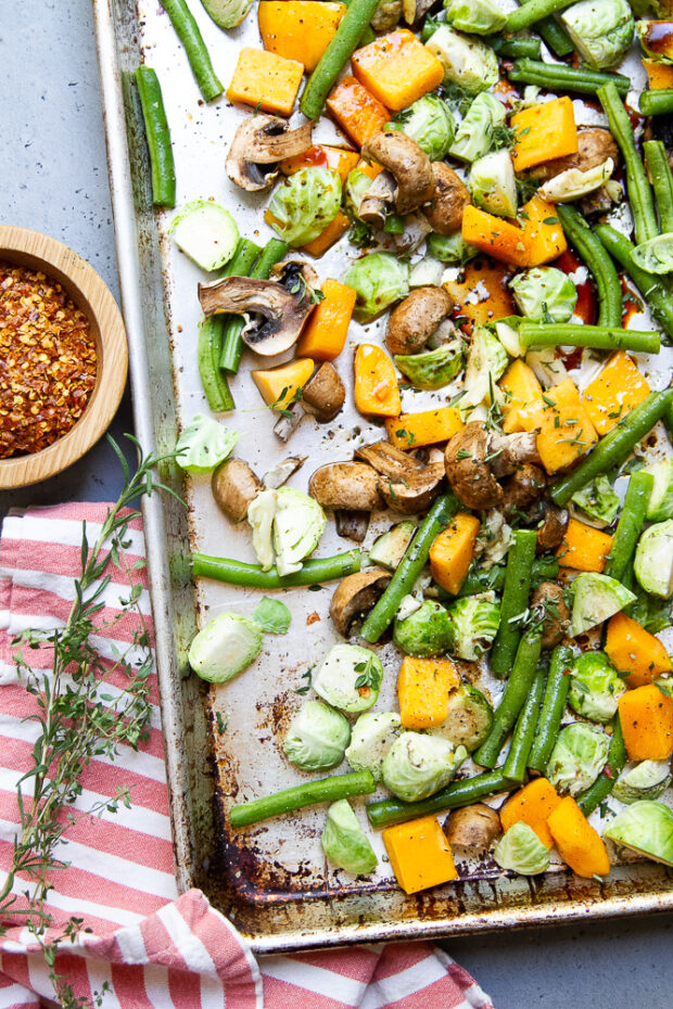 Raw vegetables tossed in balsamic vinaigrette, ready to roast.