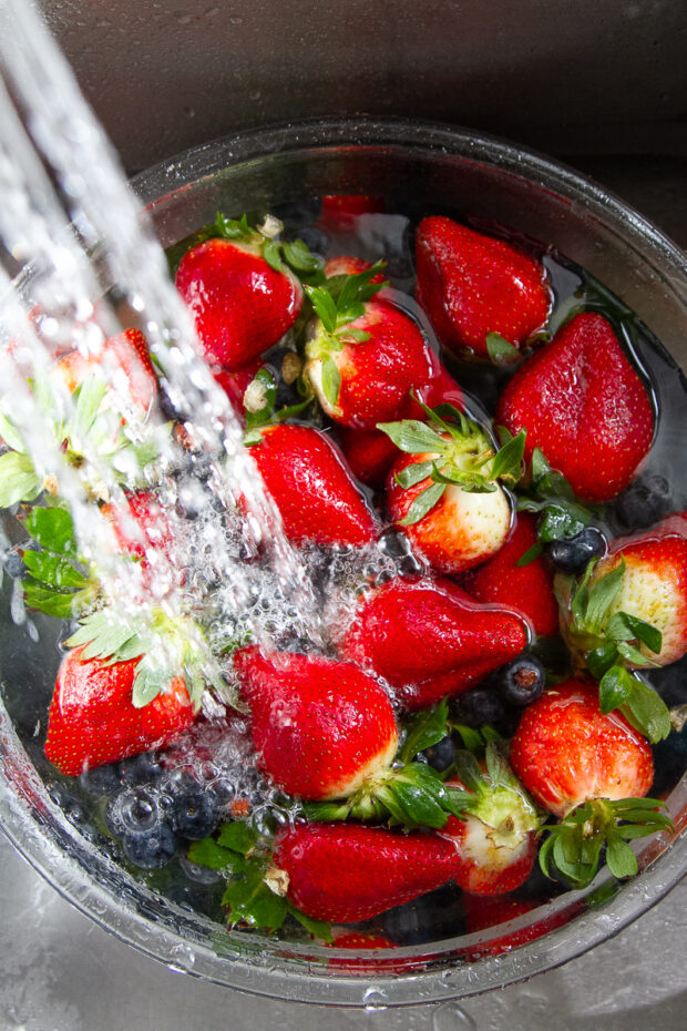 Berries in a bowl being washed