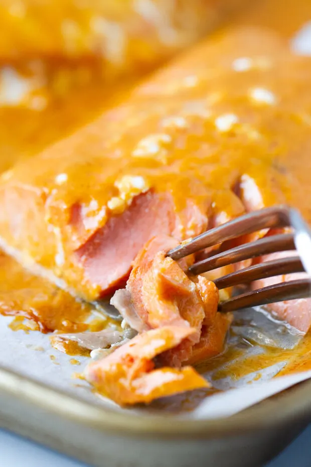 Baked buffalo salmon fillet flaked apart with a fork.