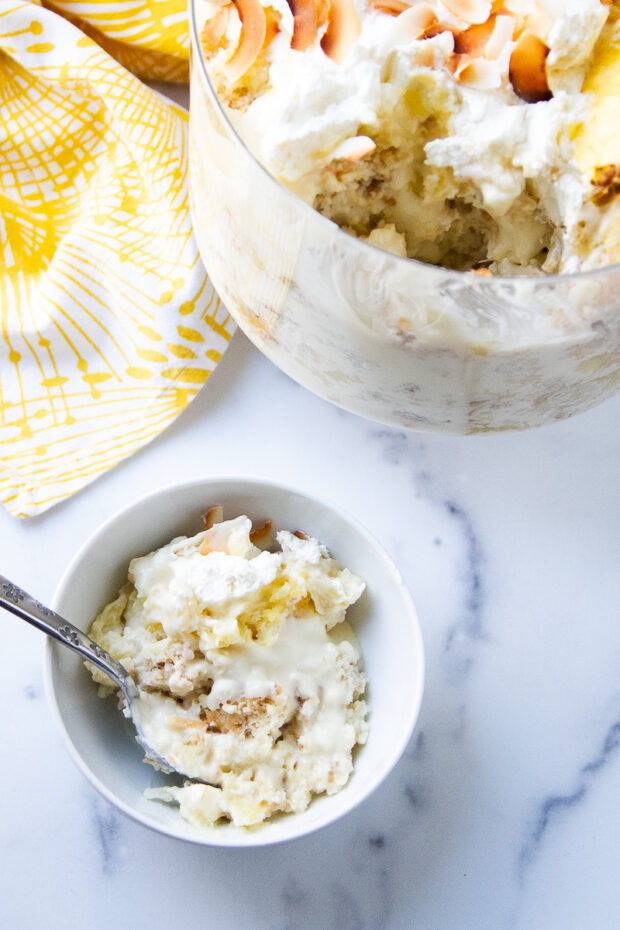 A serving has been removed from the trifle and placed in a small bowl.