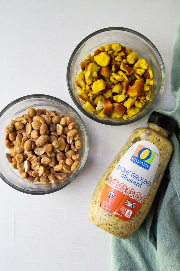 Small bowls with honey roasted peanuts and honey mustard pretzels. And a bottle of whole grain/stone ground mustard.