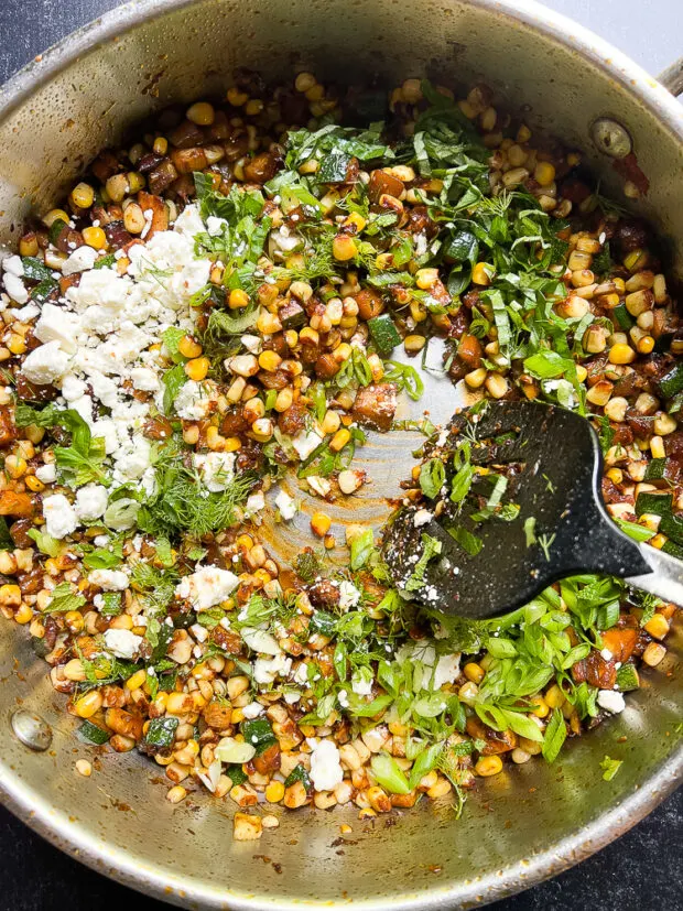 Sautéed corn & zucchini with feta and fresh herbs.