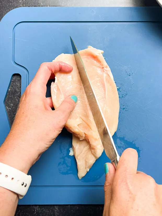 Cutting the chicken into thinner cutlets.