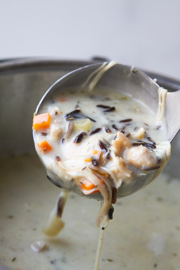 A ladle of the creamy wild rice chicken soup.