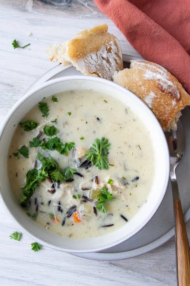 A bowl of the finished soup with some crusty bread on the side.