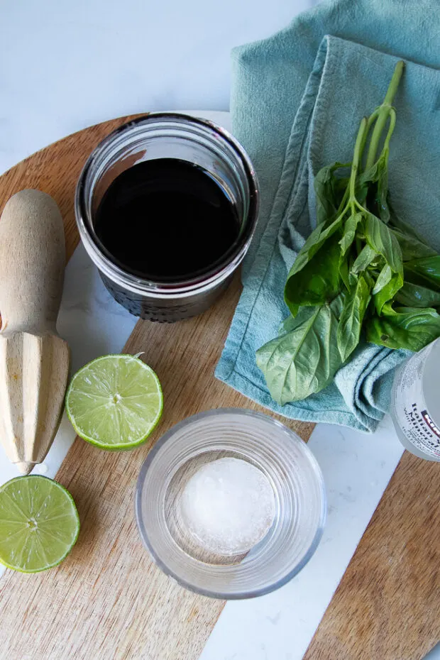Ingredients laid out for the mocktails -- hibiscus syrup, limes, sparkling water, basil.