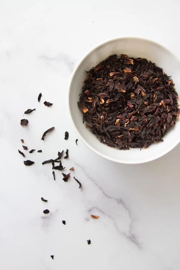 Dried hibiscus flowers in a small bowl.