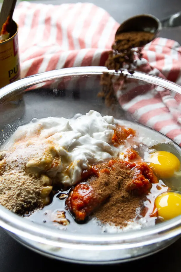 Chai Spice added to a glass bowl with the rest of the pumpkin pie ingredients.